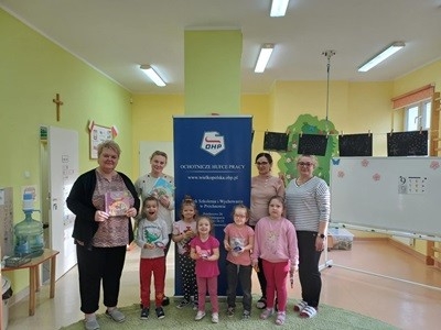 grupa dzieci przedszkolnych podczas głośnego czytania