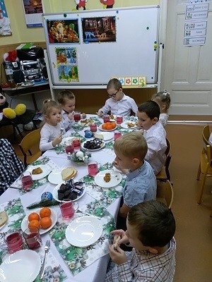 dzieci siedzą przy stole wigilijnym 